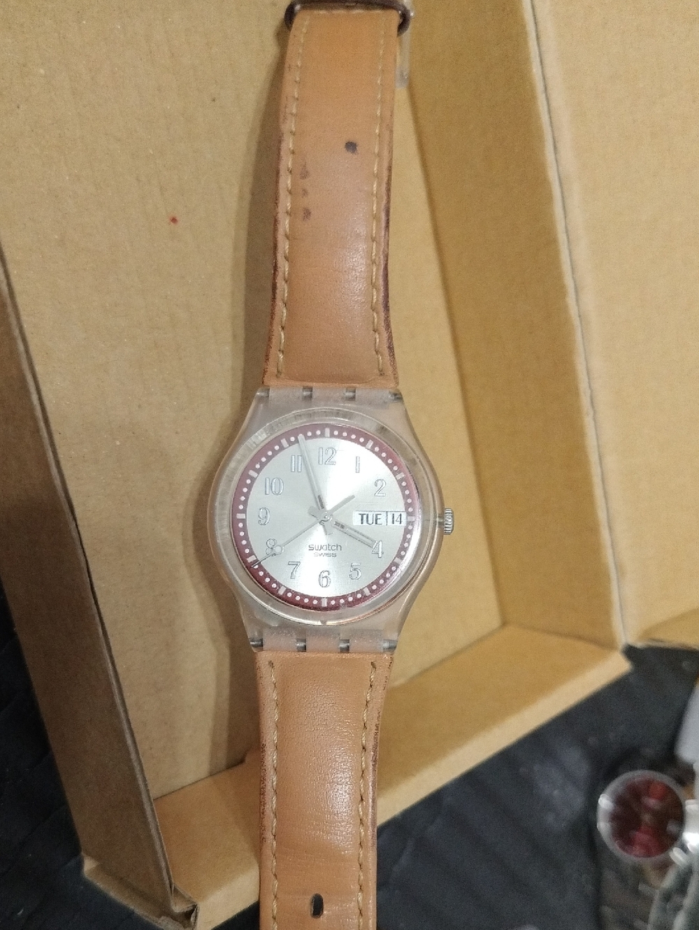 Swatch Silver Dial Watch with Tan Leather Strap and Red Accent